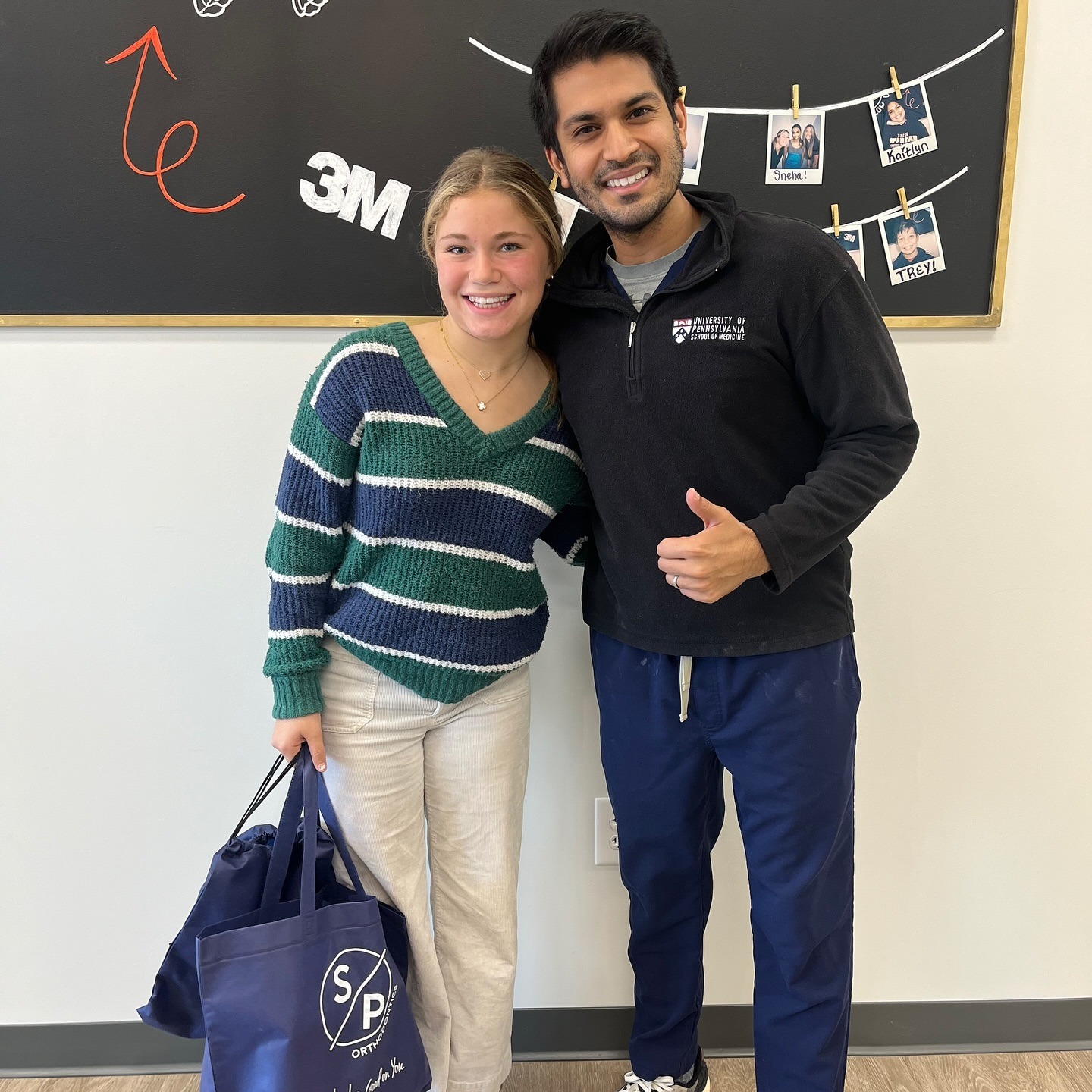 Smiling patient with braces and orthodontist in SP Orthodontics office, showcasing personalized care and a welcoming environment.